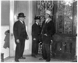 Three Men by a Doorway