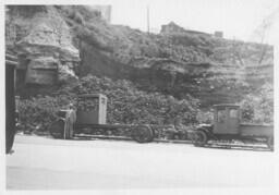 Man Standing near Two Trucks