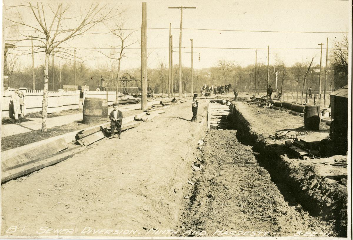 Children examine the sewer diversion project at 9th and Hardesty