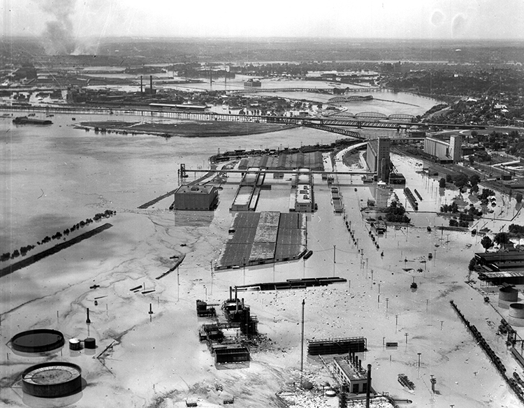 Fairfax Industrial District, looking south toward the confluence of the Kaw and Missouri rivers. Smoke from the fires along Southwest Boulevard is visible in the top left.