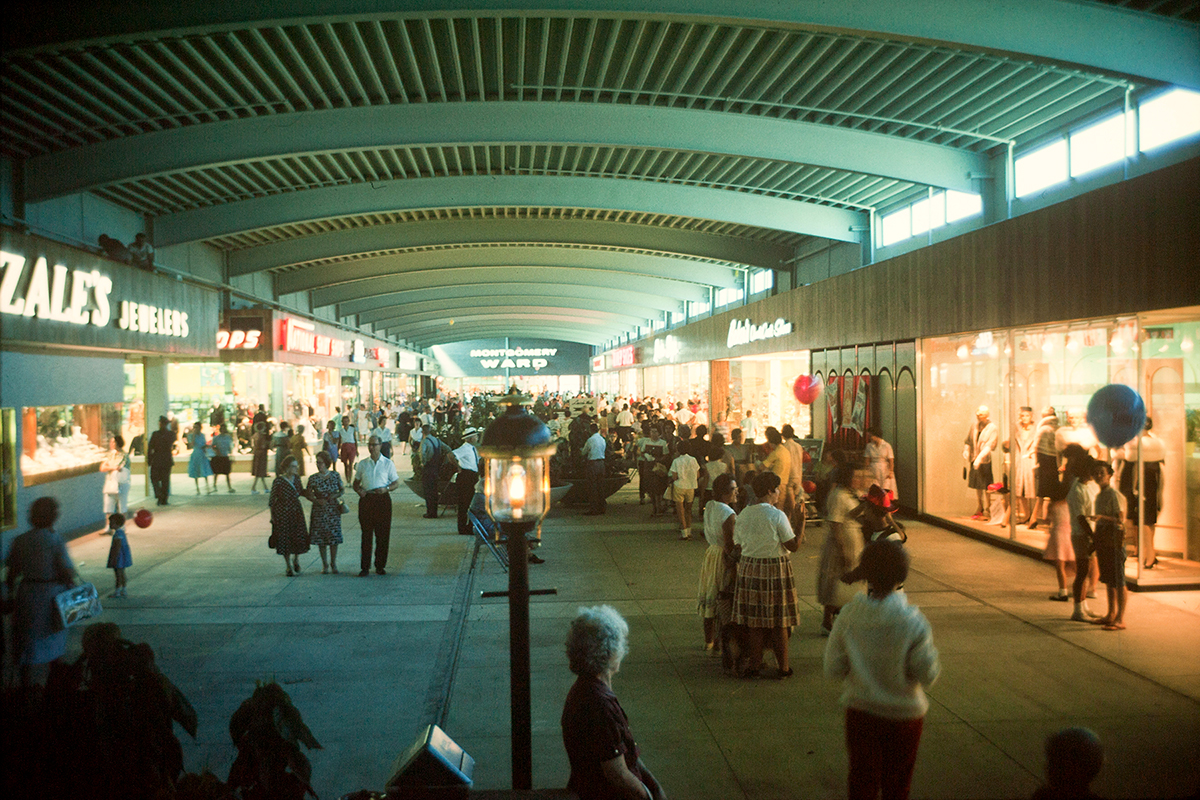 Interior view of the Ward Parkway Shopping Mall. Retail storefronts and shoppers can be seen.