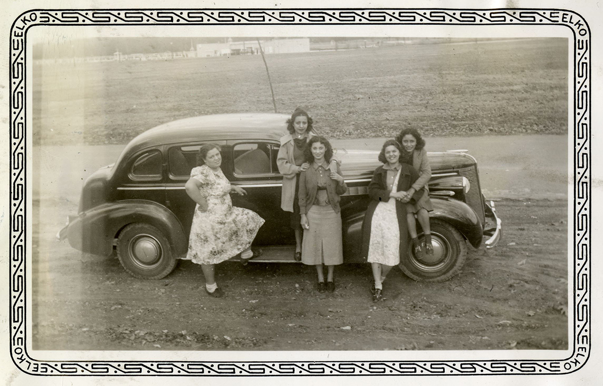 Young women pose around a car in Swope Park, November 11, 1938.