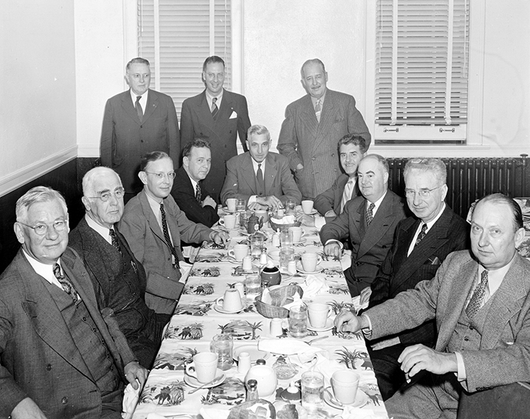 Mayor Kemp (seated center) having lunch with city council members in 1946.