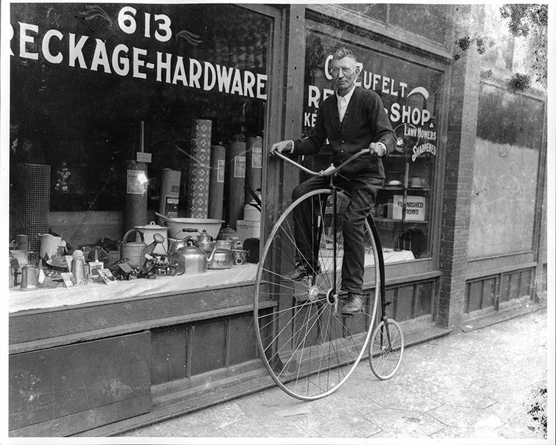 Man Riding a High Wheel Bicycle