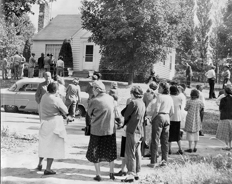 Onlookers outside Bonnie Heady’s home in St. Joseph, Missouri, while authorities search the property. |THE KANSAS CITY STAR