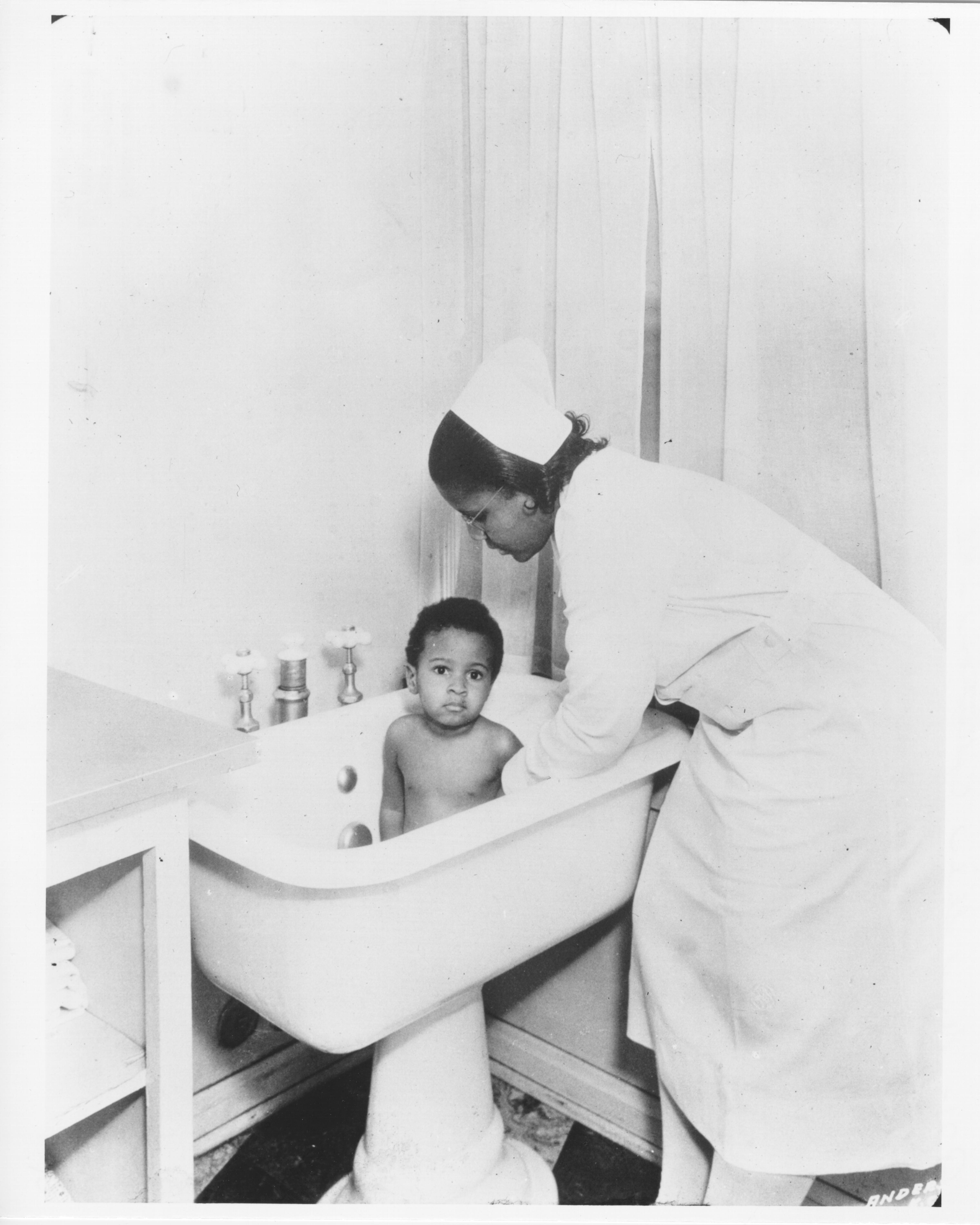 Bathing her baby, Florence Home for Colored Girls, Kansas City, Missouri, circa 1930s