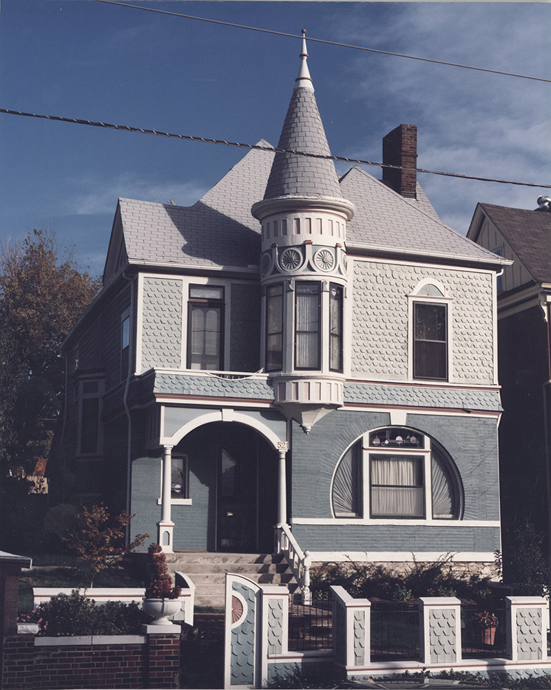 Photo of a blue and gray Queen Anne style house