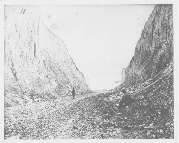 Looking north along Delaware between cut-through bluffs toward Missouri River