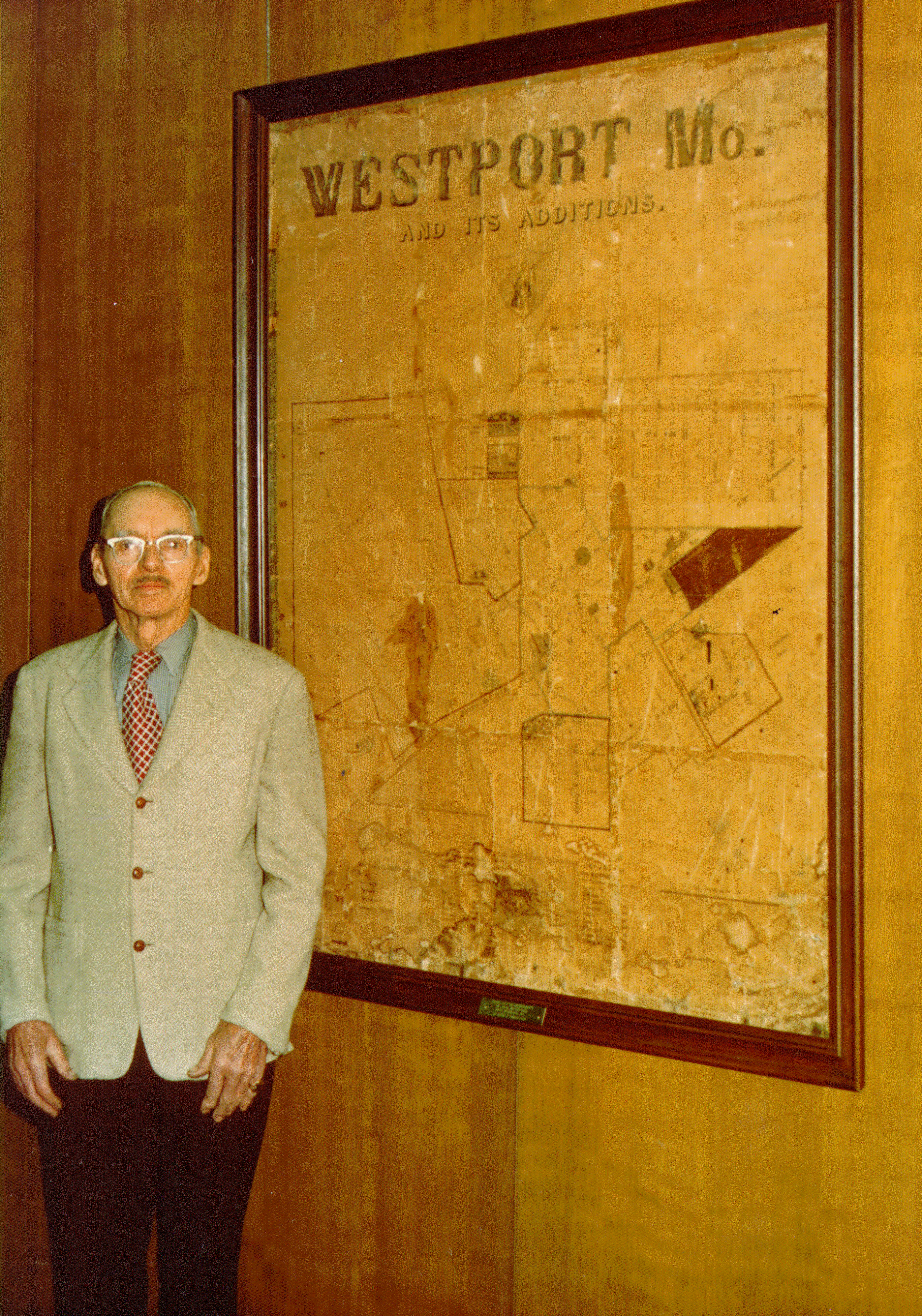 Westport mechanic Claude Halleran posed next to the map his family kept.