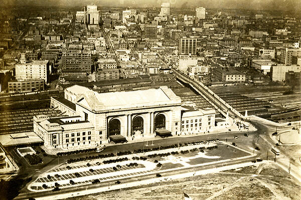 Aerial city view showing a train station in the foreground