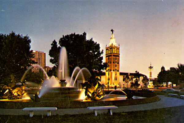 Color photo of an illuminated building with a tower