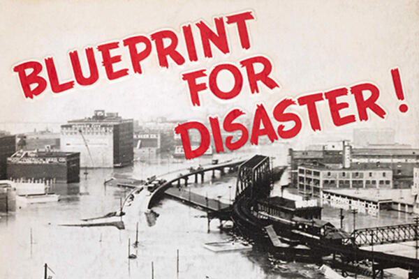 Photo of a city with the text "Blueprint For Disaster!" overlaid