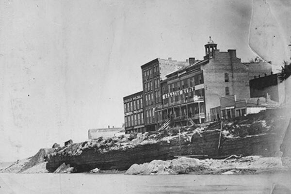 Black and white photo of a building on the bluff along the Missouri River