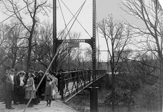 Black and white photo of a small suspension bridge